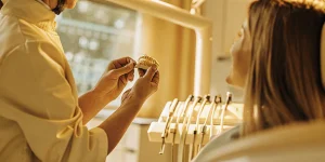 Dentist explaining a dental crown and filling to a patient