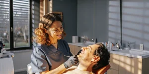 Dental hygienist preparing for a preventive dental cleaning and exam