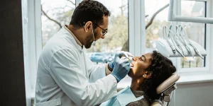 Dentist discussing sleep apnea oral appliance care with a patient