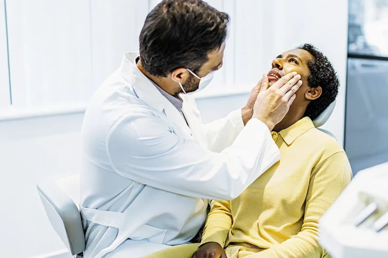 Dentist evaluating a patient with tooth pain when biting