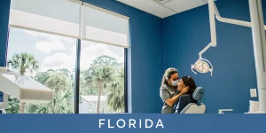 Dentist comforting a patient with tooth pain in a modern dental office