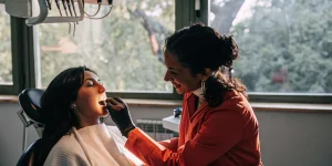 Dentist performing a gum examination on a patient in a modern dental office