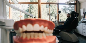 Dr. Anand Shah consulting with a patient about implant-supported denture options in a modern dental office