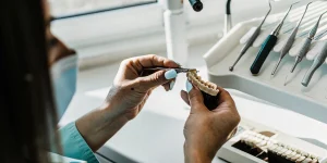 Dental professional preparing porcelain veneers in a modern dental office