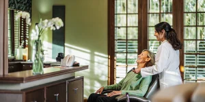 Bright modern dental office interior with a patient smiling after a teeth whitening consultation